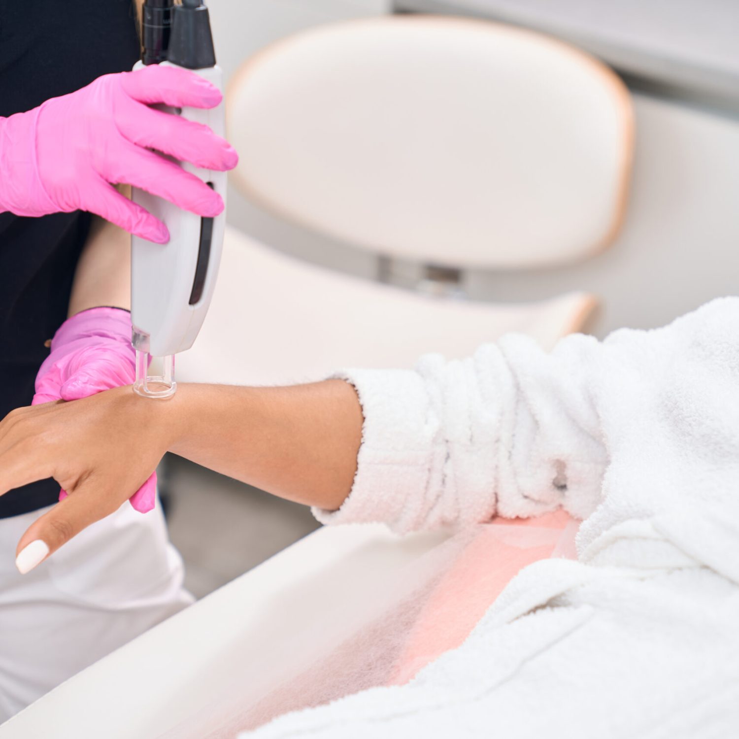 Safe procedure of laser hair removal of hands in a modern aesthetic medicine salon
